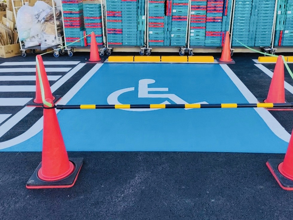 尾張旭市の施設駐車場にて、青地に白の国際シンボルマーク（車椅子マーク）を塗装した施工後の様子
